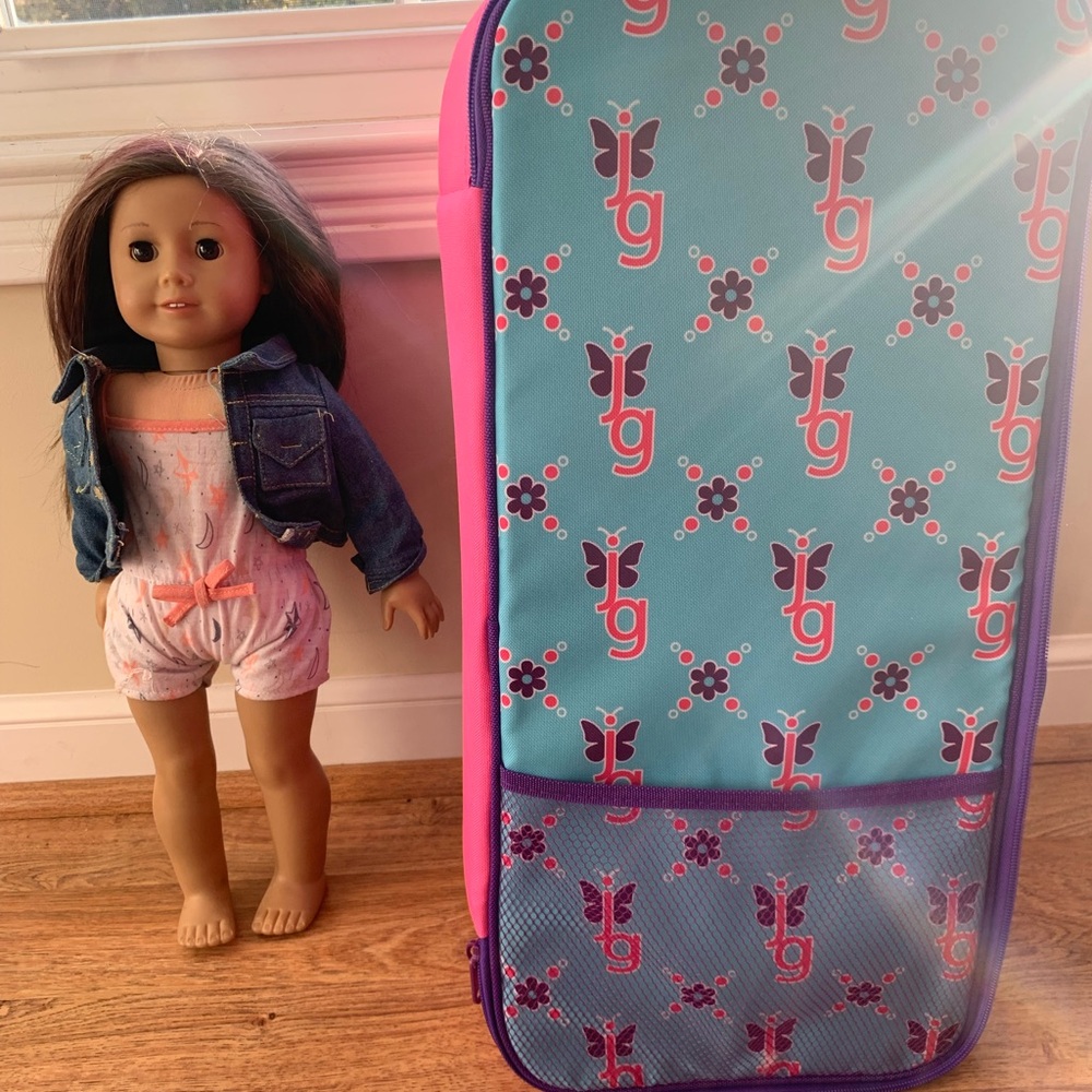 American Girl Truly Me Doll with travel case, clothes, and violin.